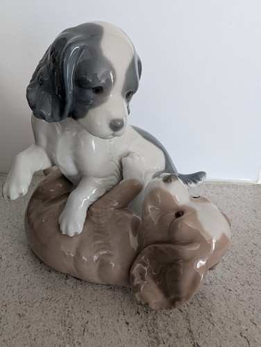 Nao lladro playing puppies - by,